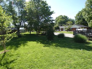 Backyard patio before 6-foot vinyl privacy fence installation in Collinsville, IL (view 1 of 3)
