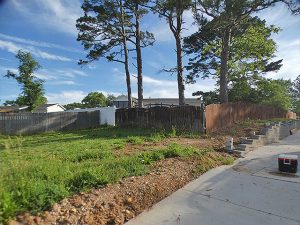 Pool area before 6-foot white vinyl privacy fence replacement in Arnold, MO (view 1 of 2)