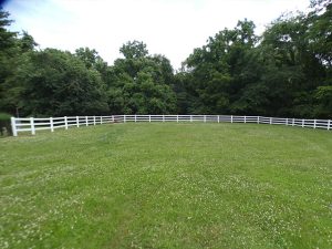 White vinyl Coronado 3-rail split rail fence after installation in Barnhart, MO (view 1 of 4)