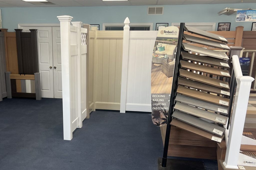 Solid fence panels in white, tan and wood-grain colors in the Arnold showroom